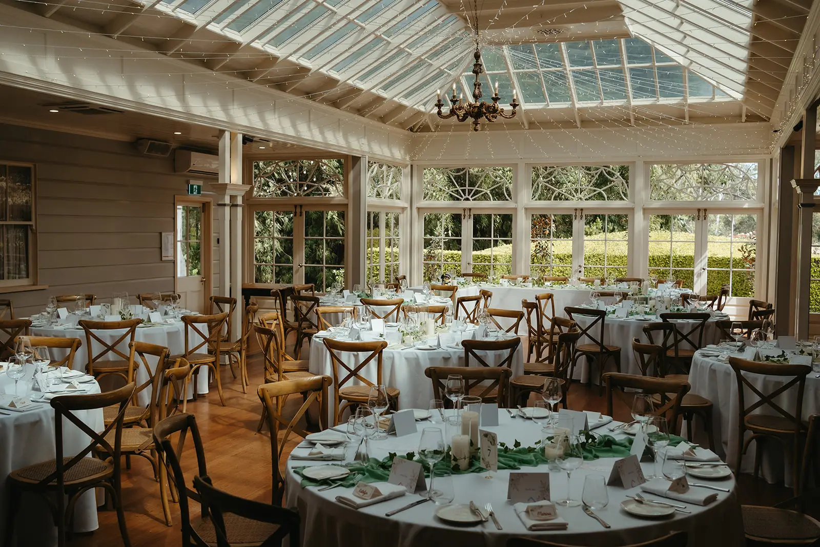 The glass-roofed Conservatory set with round tables for dinner, Gabbinbar Homestead, Toowoomba