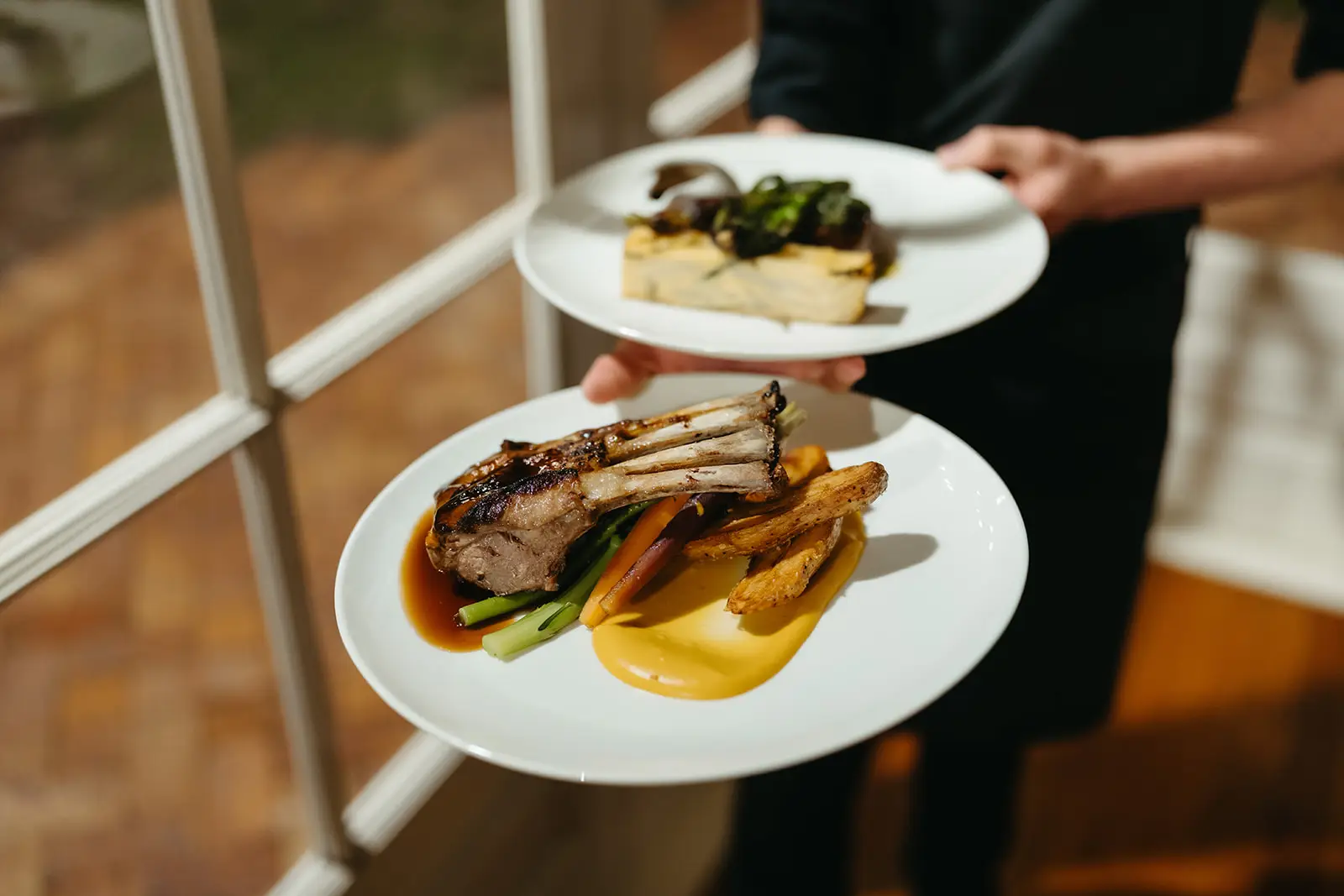 Plated lamb and fish carried past the Conservatory windows, Gabbinbar Homestead