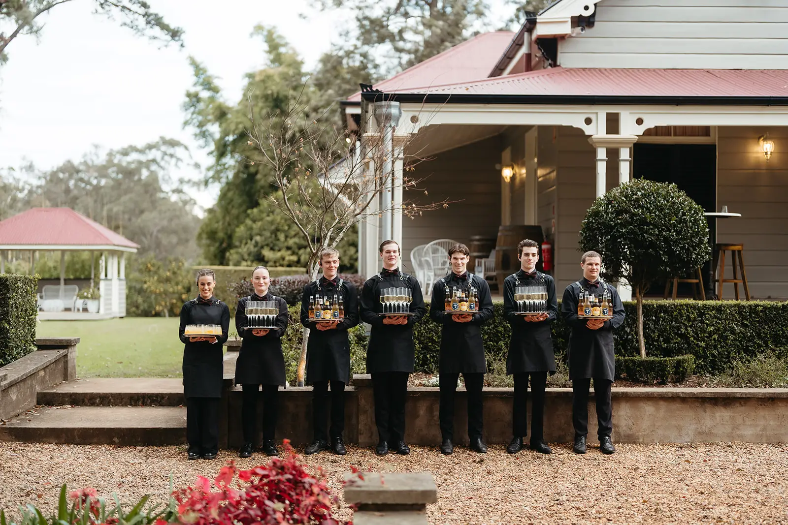 The groomsmen lined up along the verandah steps with drinks, Gabbinbar Homestead