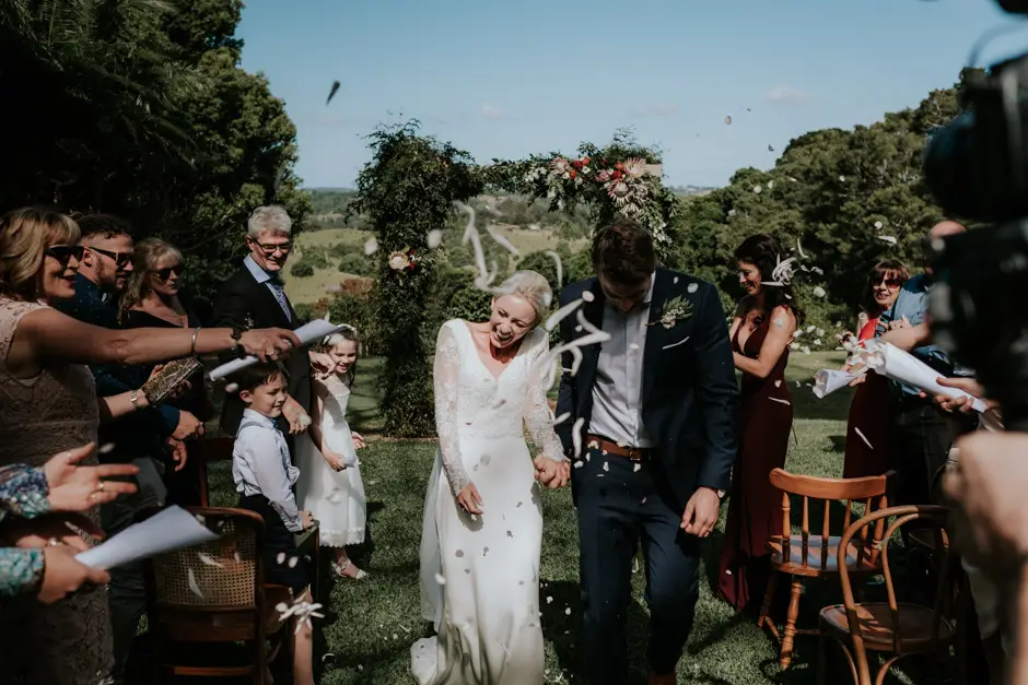 Confetti and streamers as Jessica and Jarrod come back down the aisle, Eureka