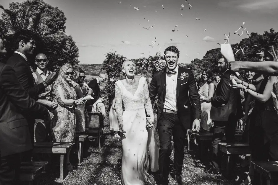 Jessica and Jarrod laughing through the confetti on the recessional, Goremans Road