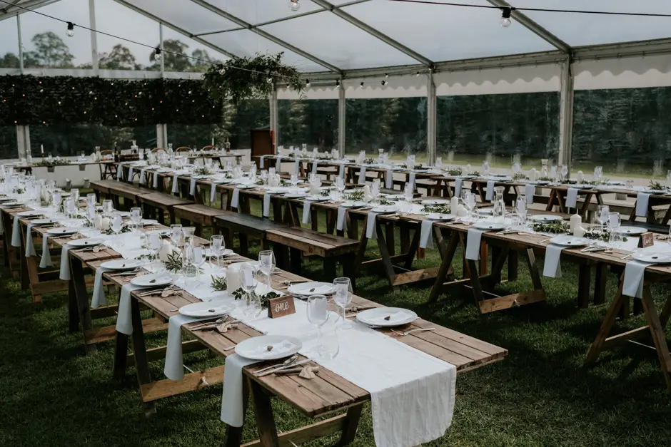 Long timber tables set under the marquee before the reception, Eureka