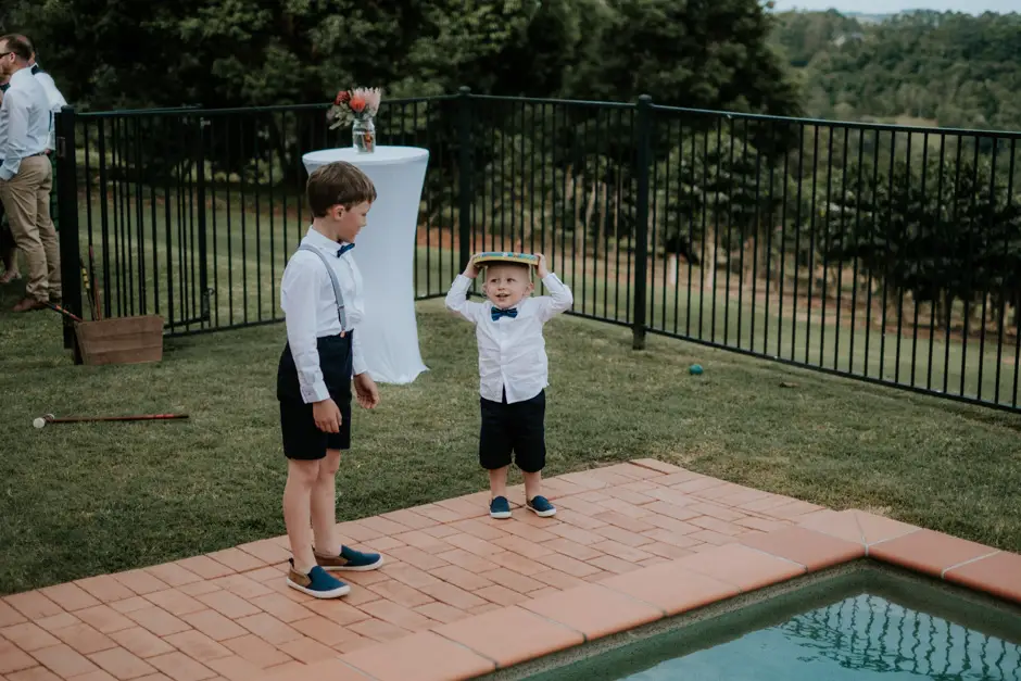 Two young boys playing beside the pool during the reception, Goremans Road