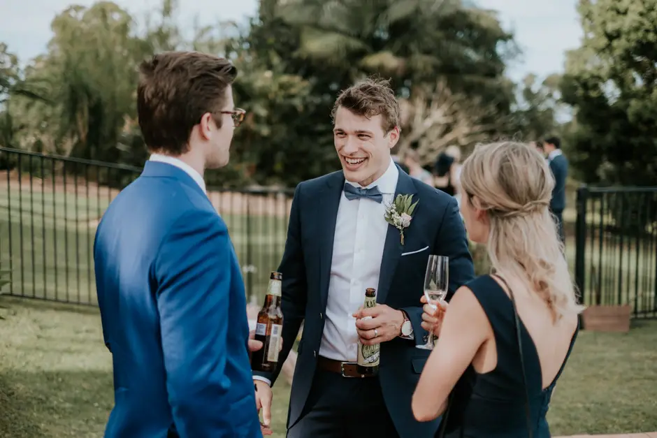 Guests talking over drinks on the lawn, Eureka