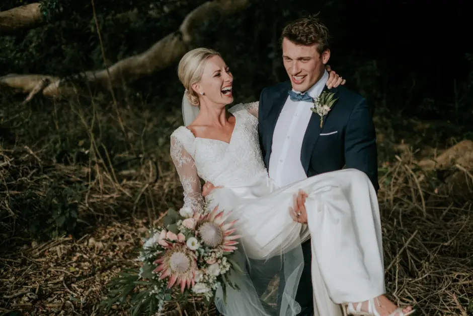 Jarrod lifting Jessica in his arms among the trees, Eureka