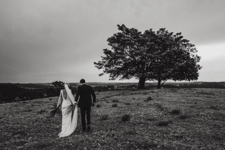 Jessica and Jarrod walking towards a lone tree in the paddock, Goremans Road