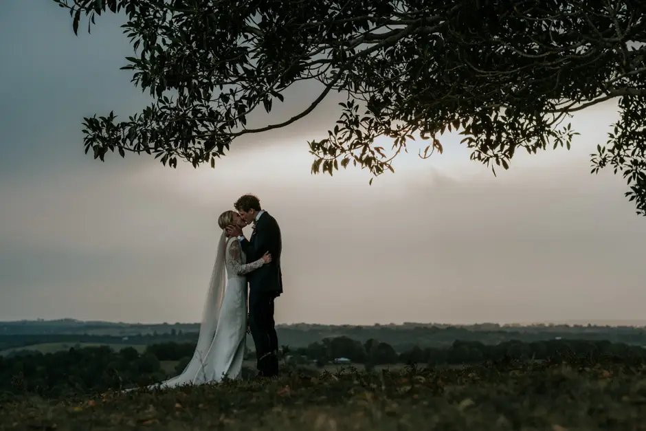 Jessica and Jarrod kissing beneath the tree at last light, Goremans Road