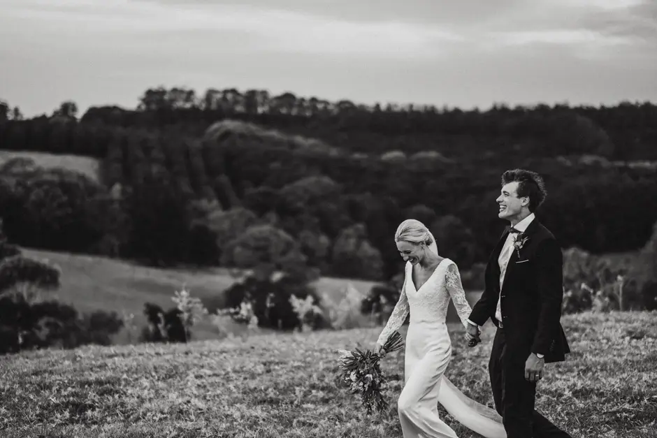 Jessica and Jarrod walking the hillside in black and white, Eureka
