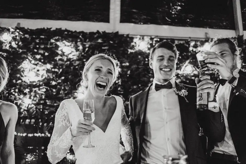 Jessica with a glass raised, and guests toasting behind them, Goremans Road