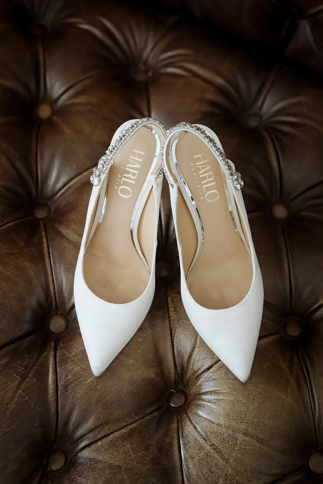 The bride's white heels on a leather chesterfield, Harvest Newrybar