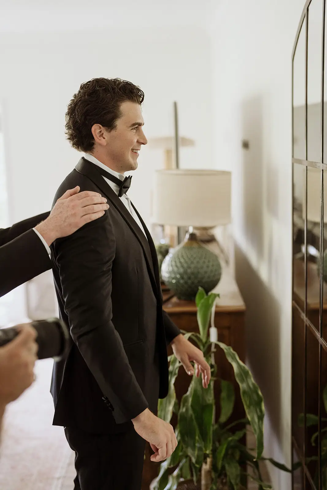Tom pulling on his tuxedo jacket, Newrybar