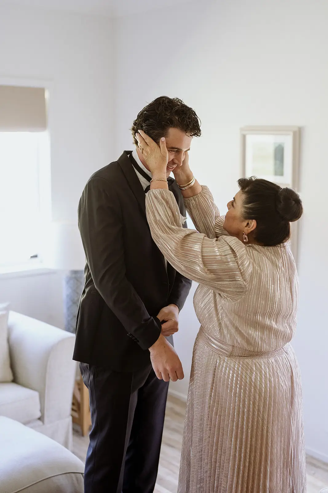 Tom's mother straightening his collar before the wedding