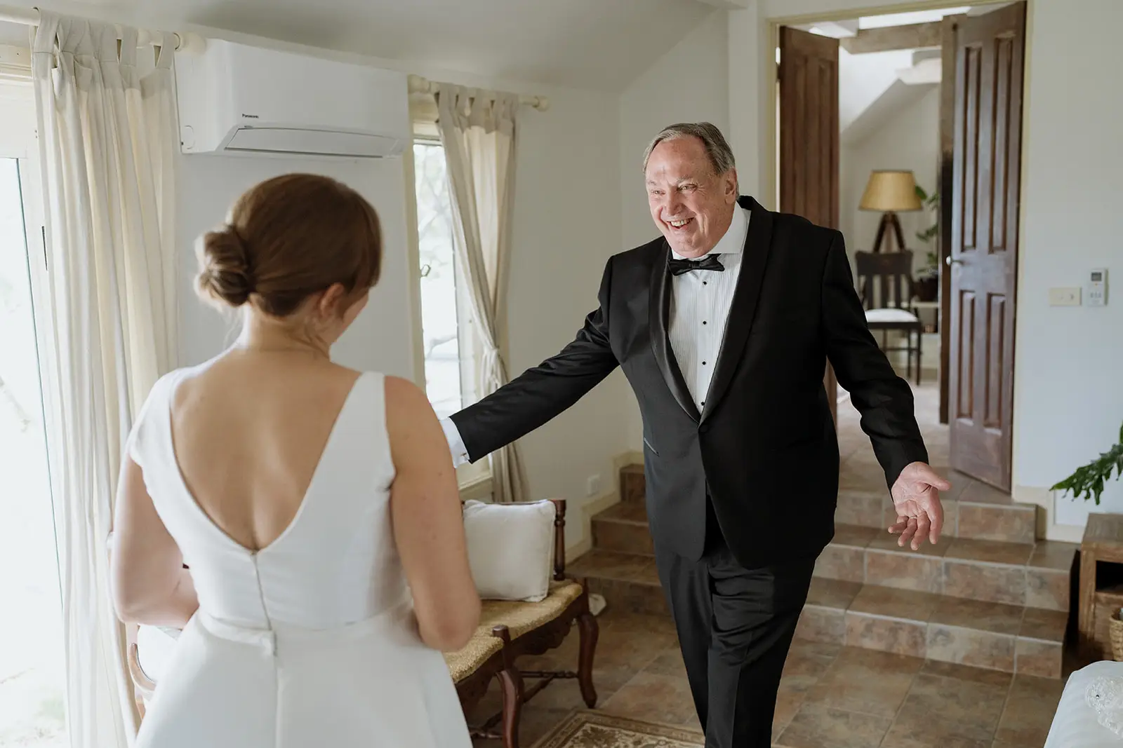 Nim's father leading her through the house, Byron Bay hinterland