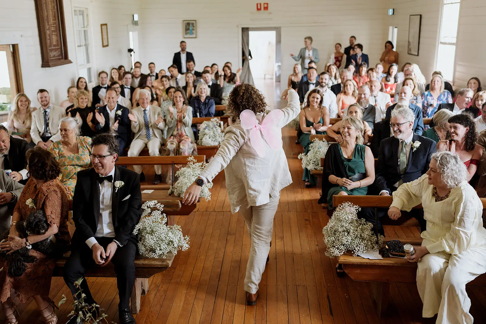 A bridesmaid dancing down the aisle, Newrybar hall