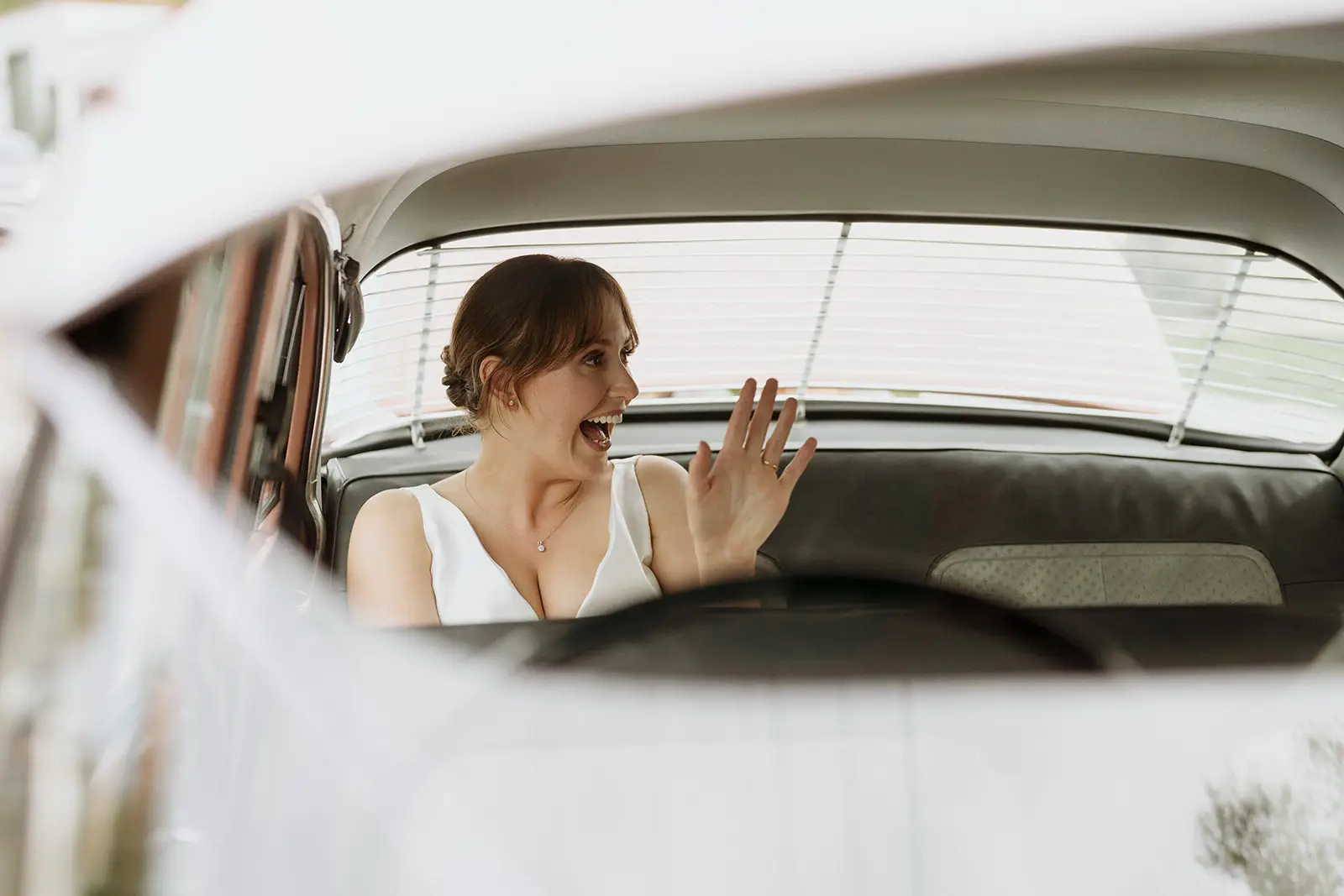 Nim waving from the window of the vintage car, Byron Bay hinterland
