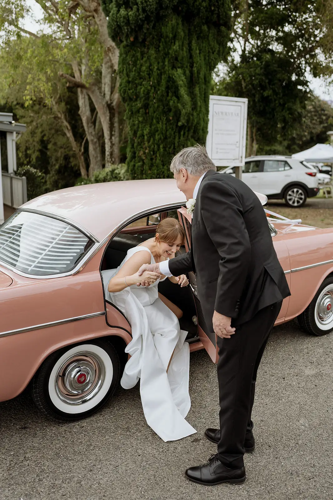 Nim's father helping her from the pink vintage car, Newrybar