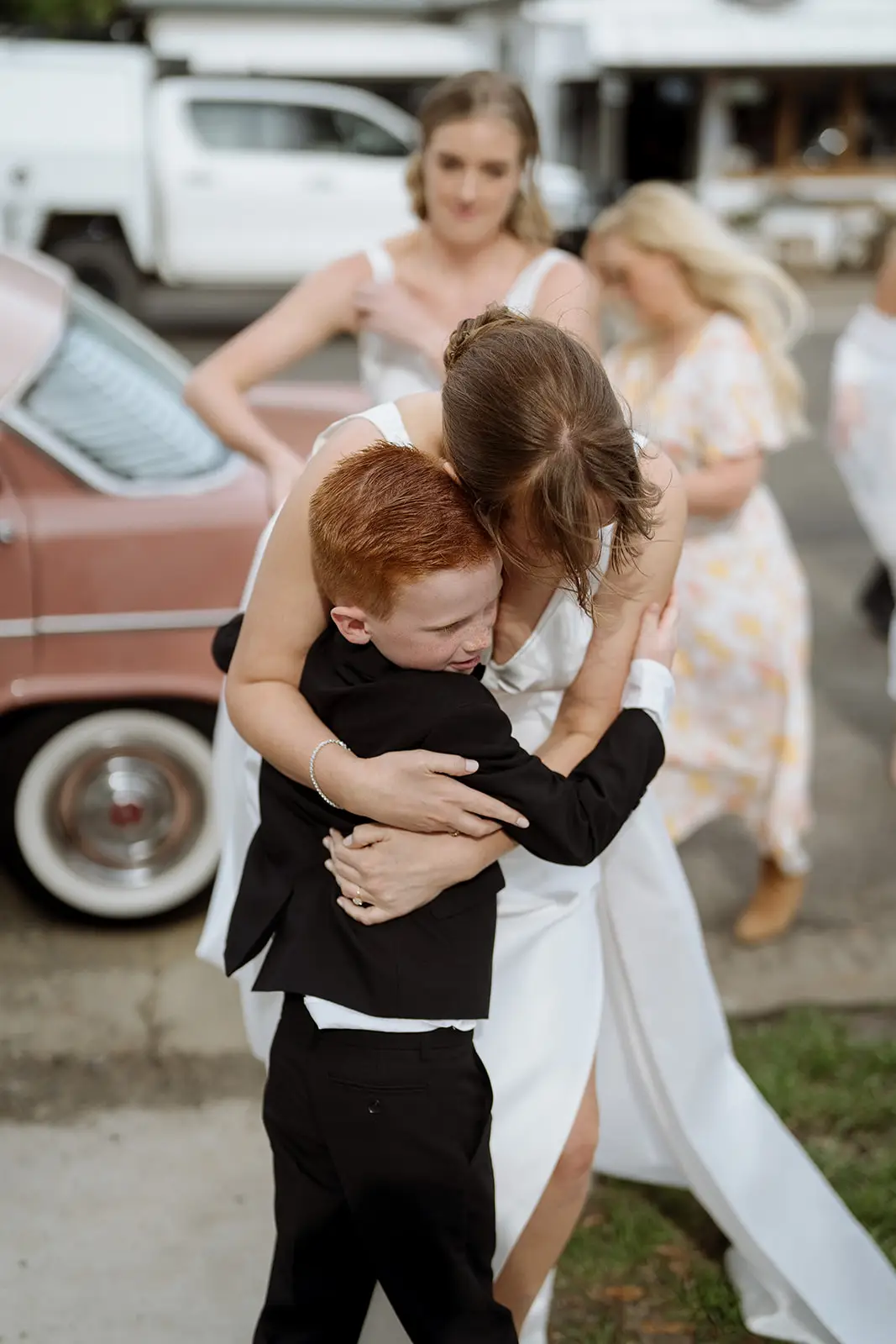 An embrace beside the vintage car before the ceremony, Newrybar
