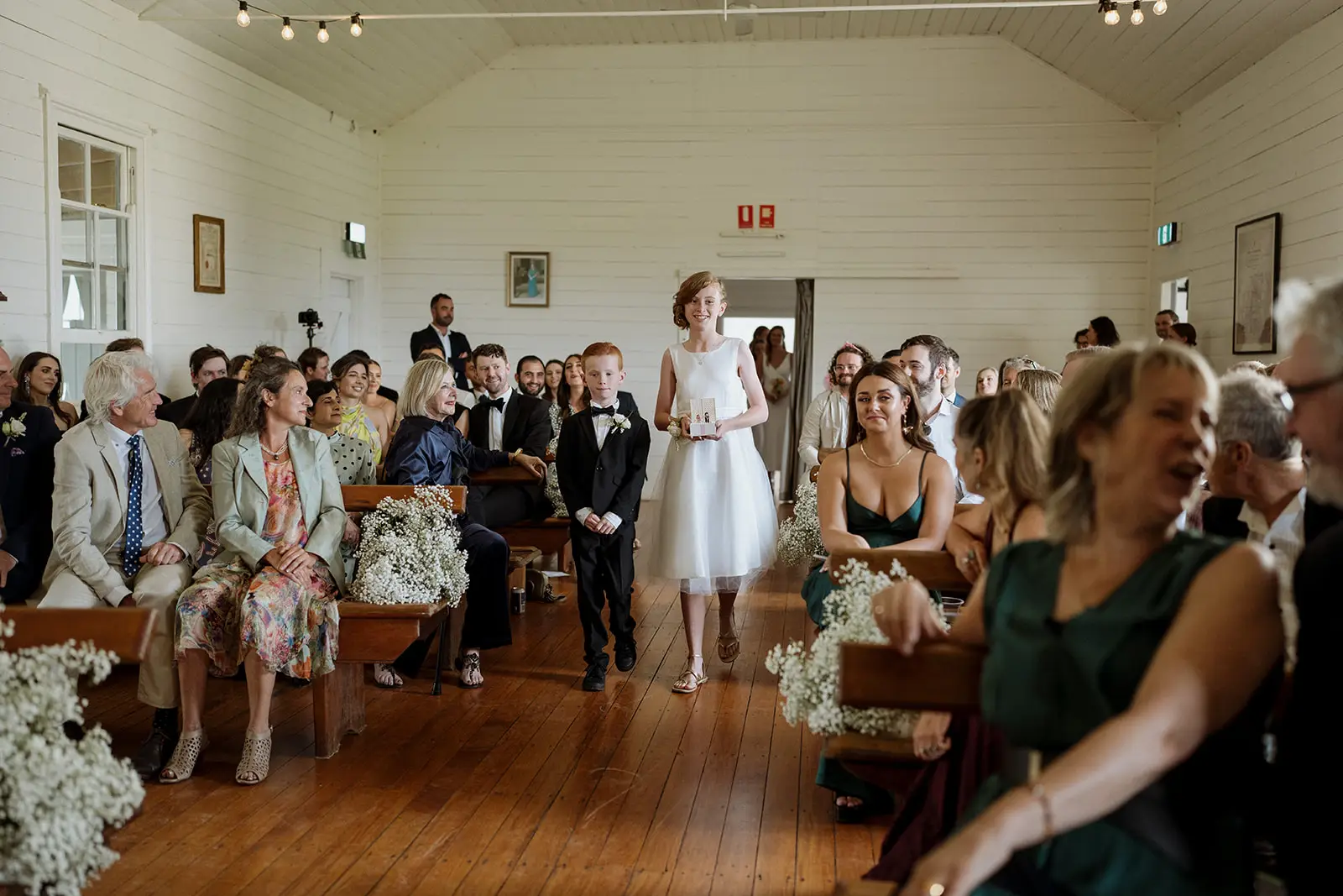 Guests turning as Nim enters the hall, Newrybar