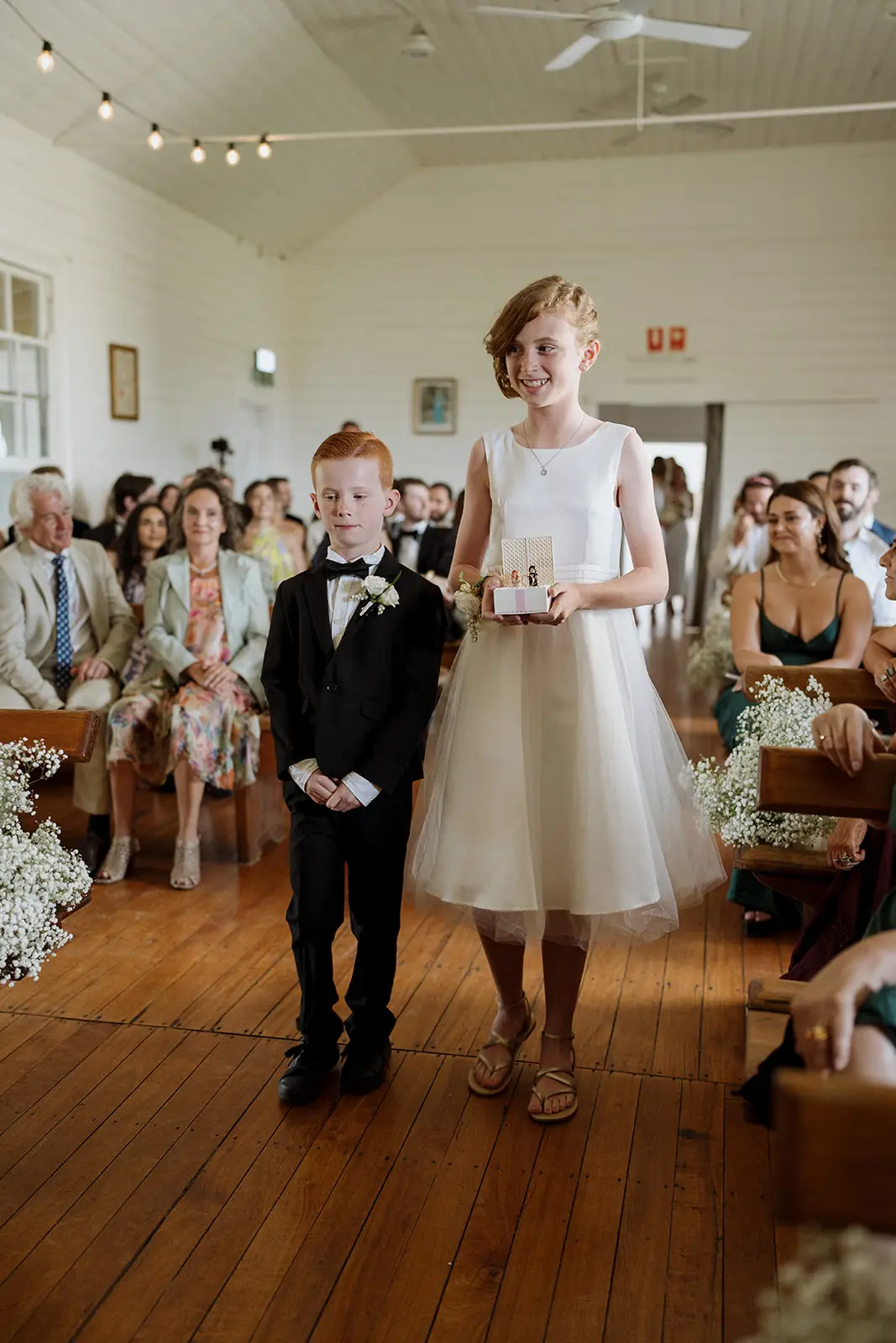 Nim walking down the aisle with her father, Newrybar hall