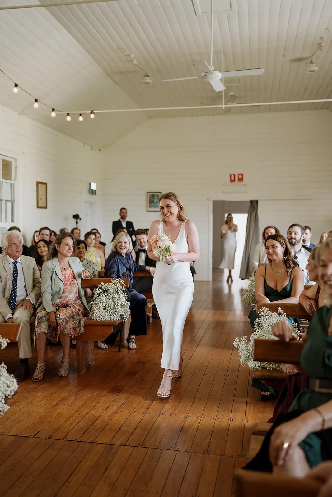 Nim carrying her bouquet down the aisle, Newrybar