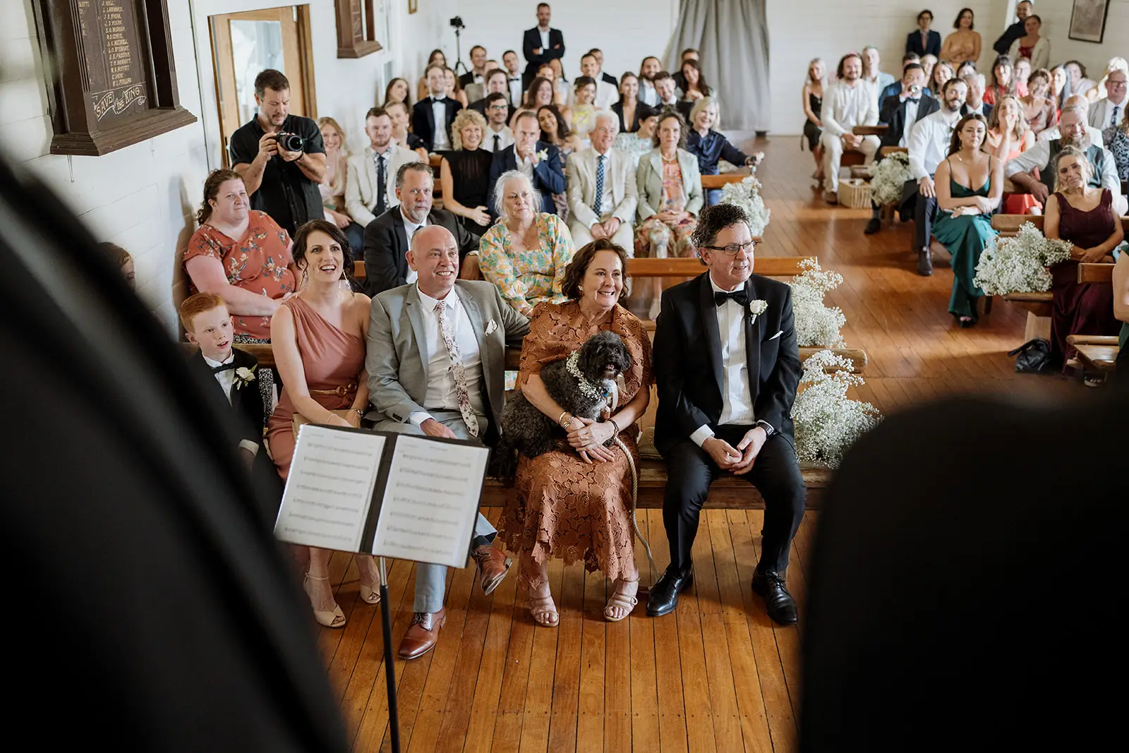 Guests watching the ceremony from the pews, Newrybar hall