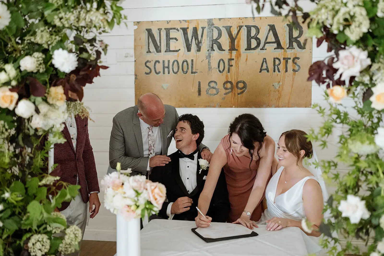 Signing the register beneath the Newrybar School of Arts sign