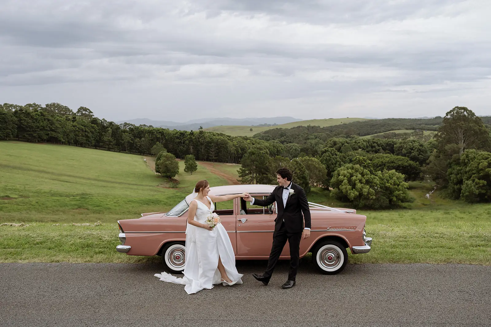 Tom and Nim with the pink vintage car in the hinterland, Newrybar
