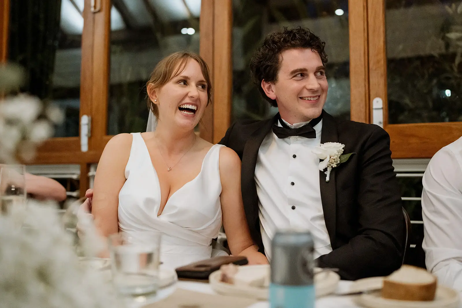Tom and Nim laughing during the speeches, Harvest Newrybar