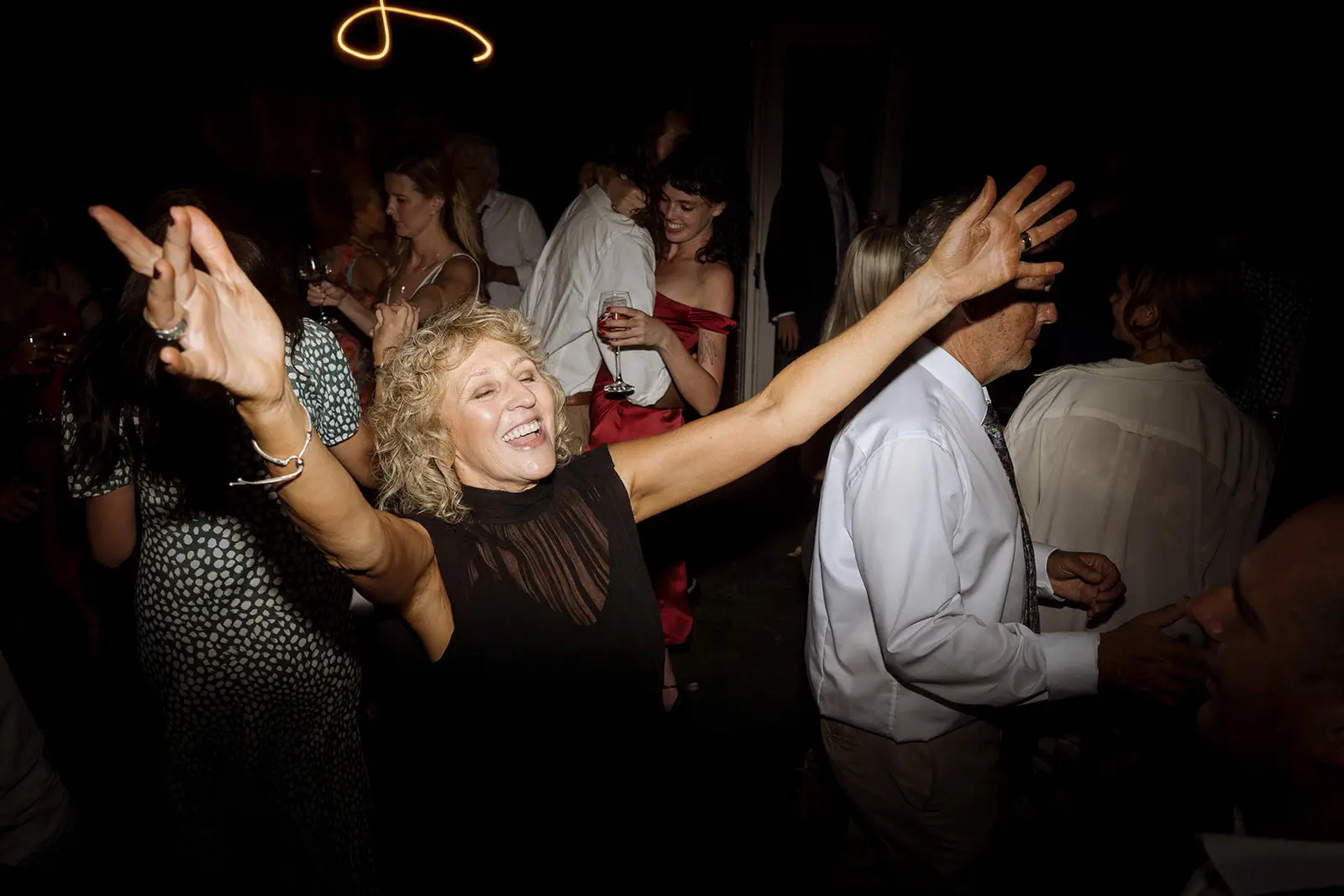 Guests dancing with arms raised, Harvest Newrybar