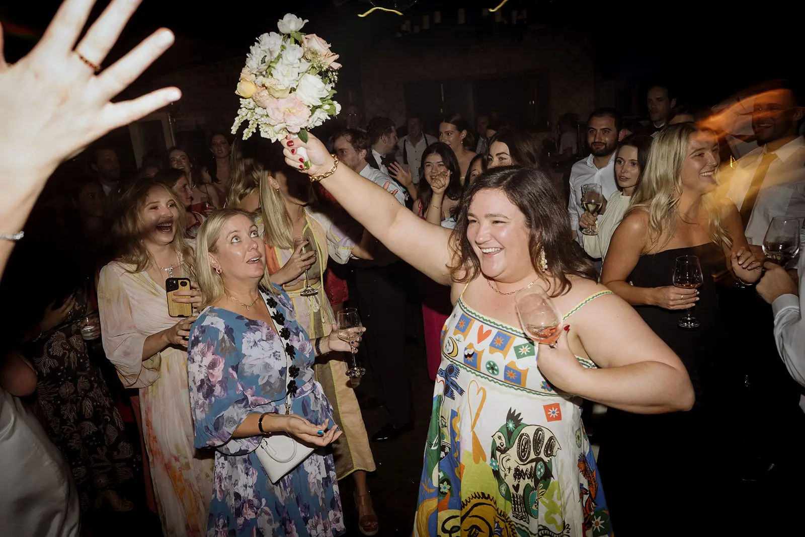 A guest holding the caught bouquet aloft, Harvest Newrybar
