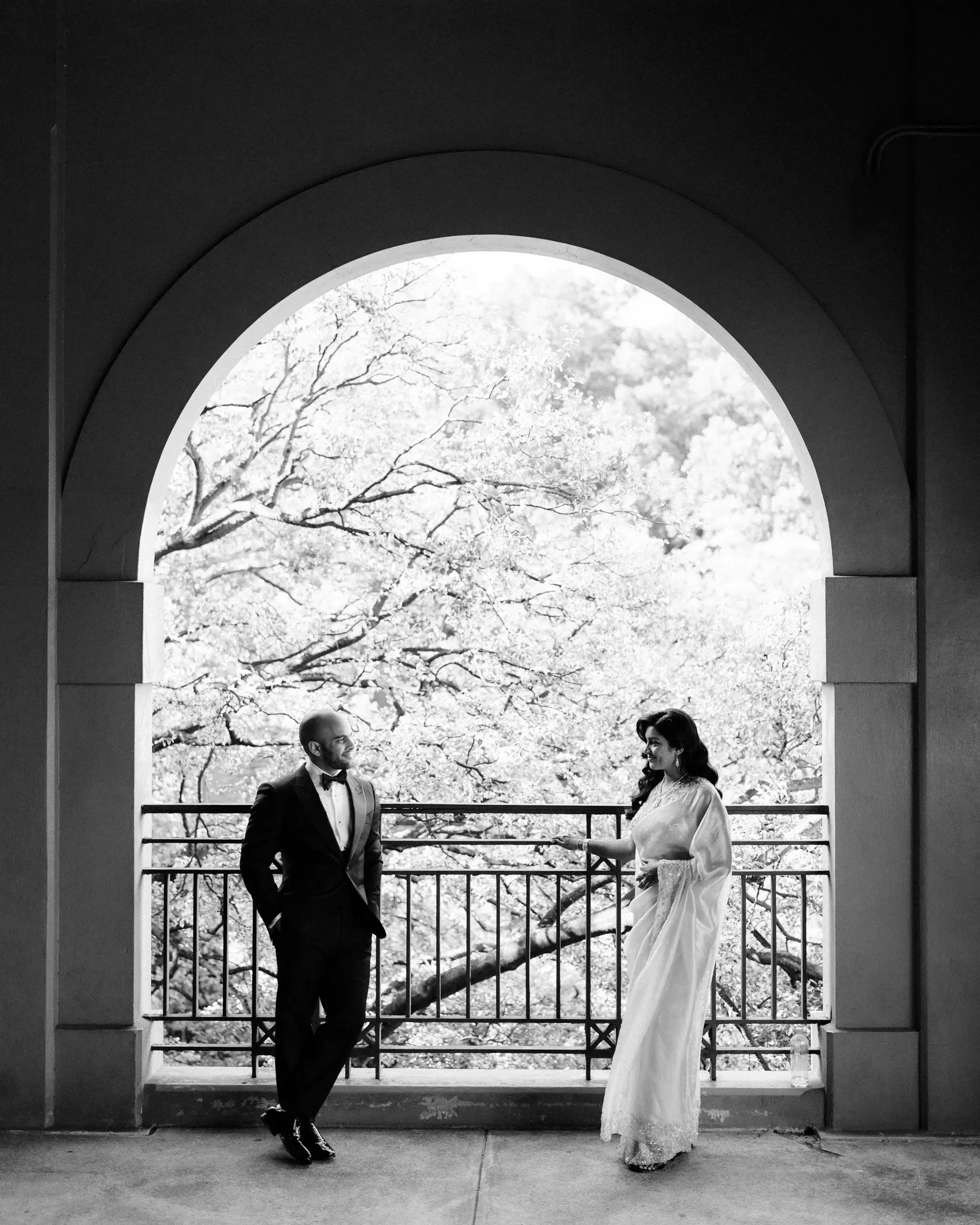 Black and white photograph of a couple framed in a stone archway