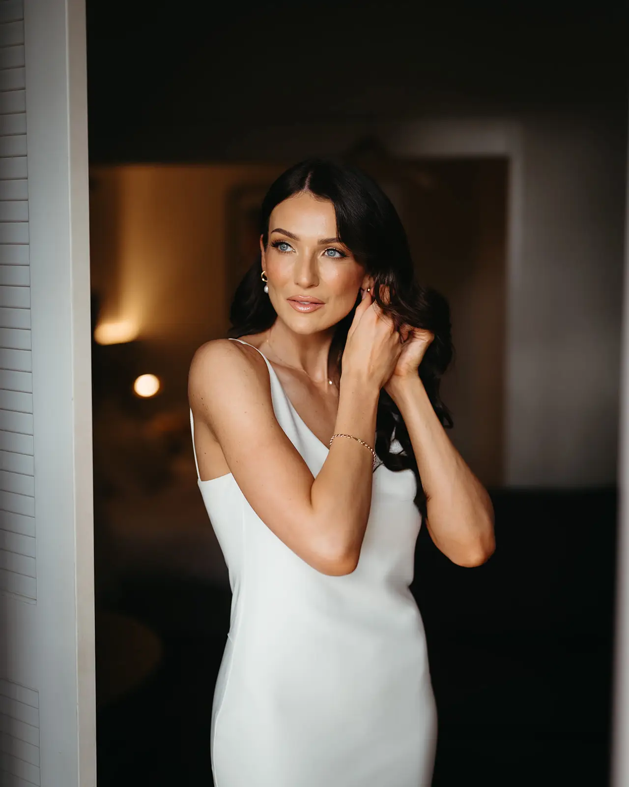 The bride in the light of the suite window before the ceremony, InterContinental Sanctuary Cove