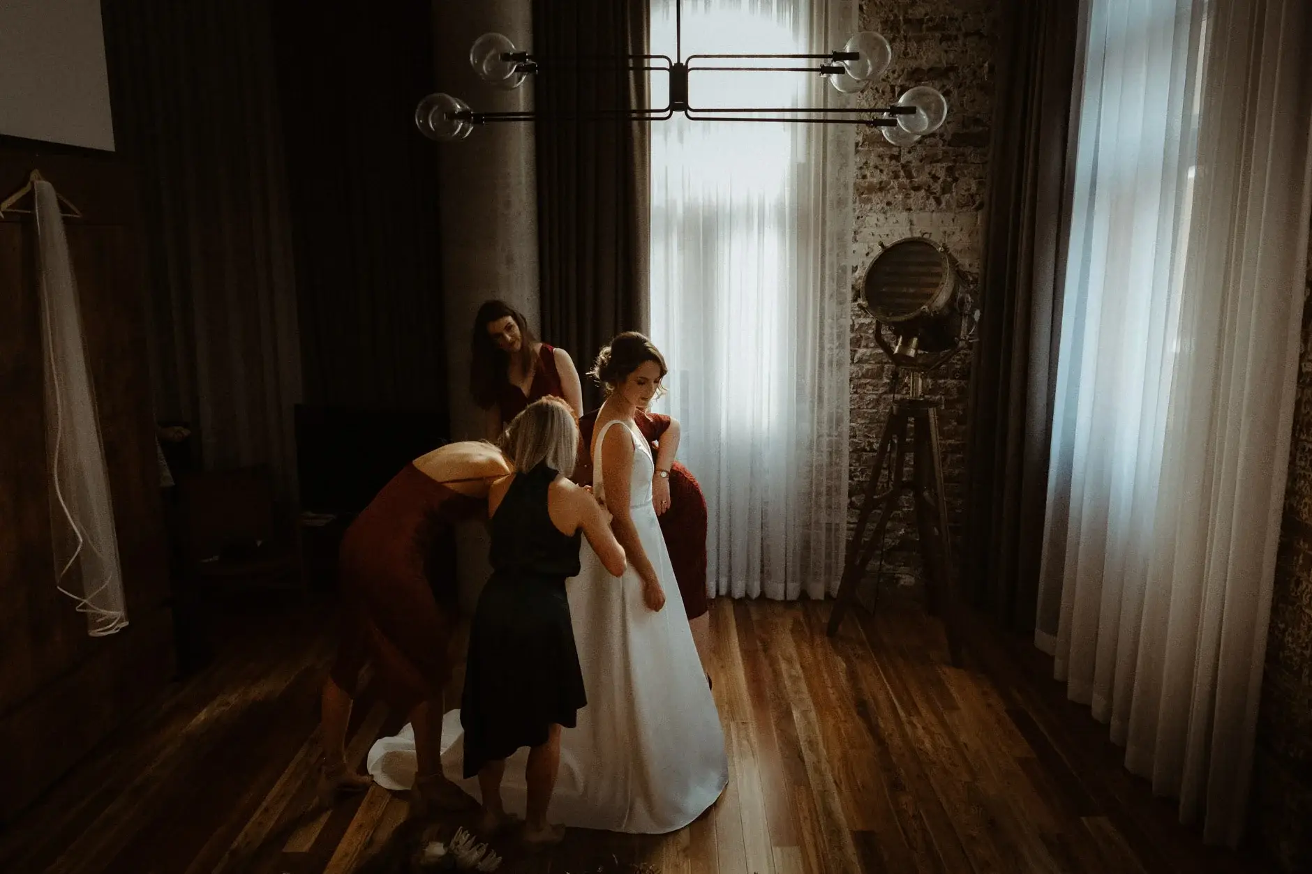 The bridesmaids helping Kath into her dress, The Old Clare Hotel