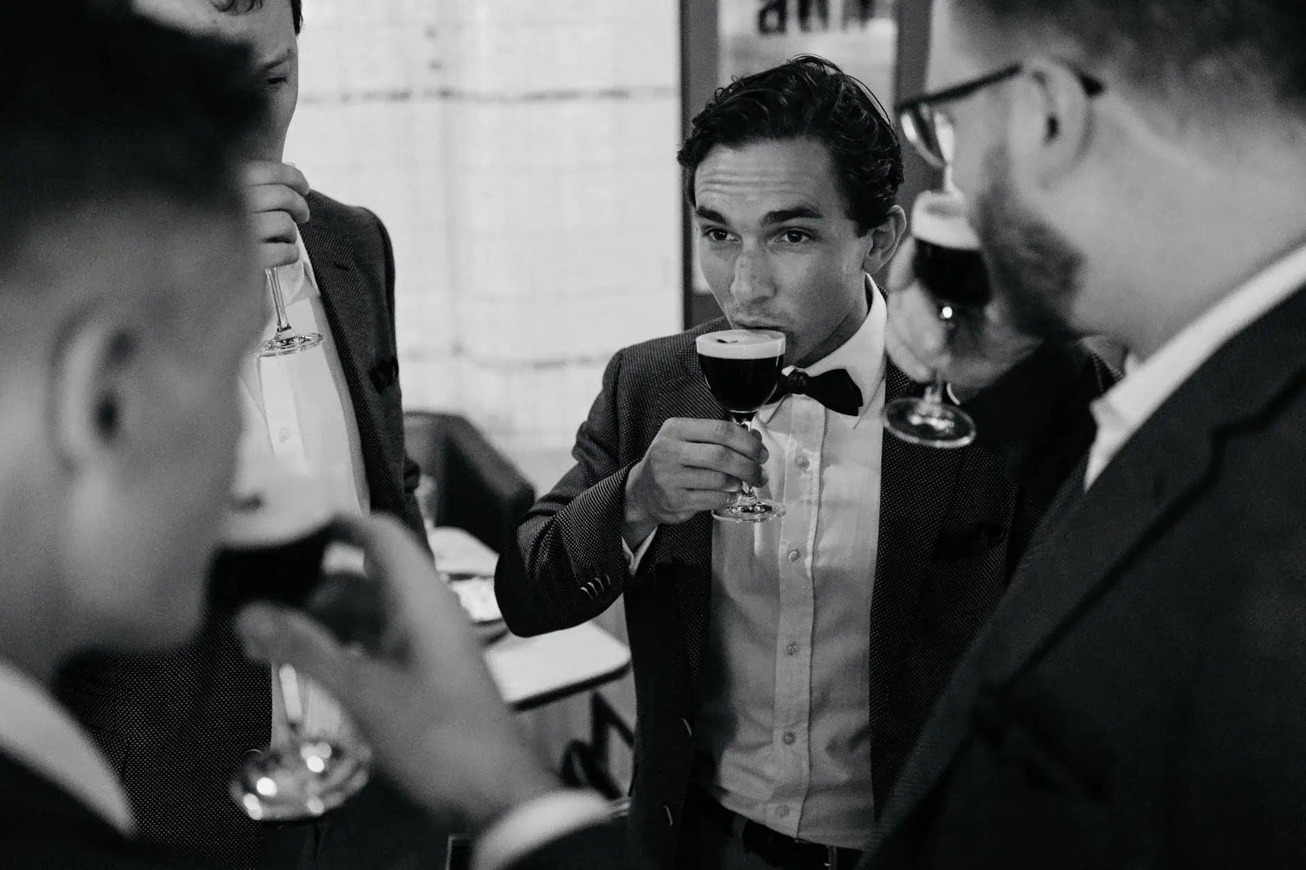 Ross and a groomsman raising red wine, black and white, Chippendale