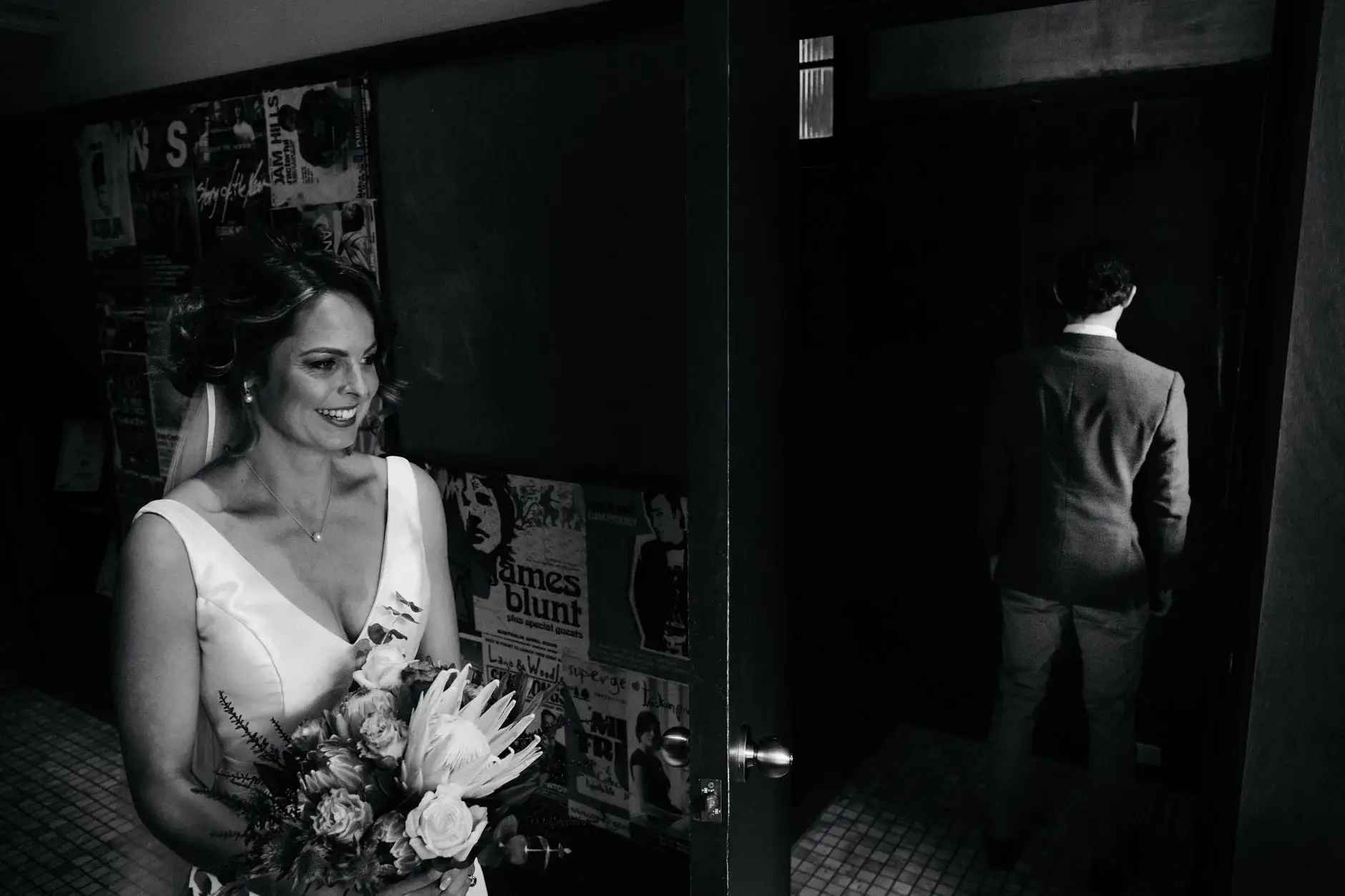 Kath with her bouquet in the dark hallway, and Ross walking ahead