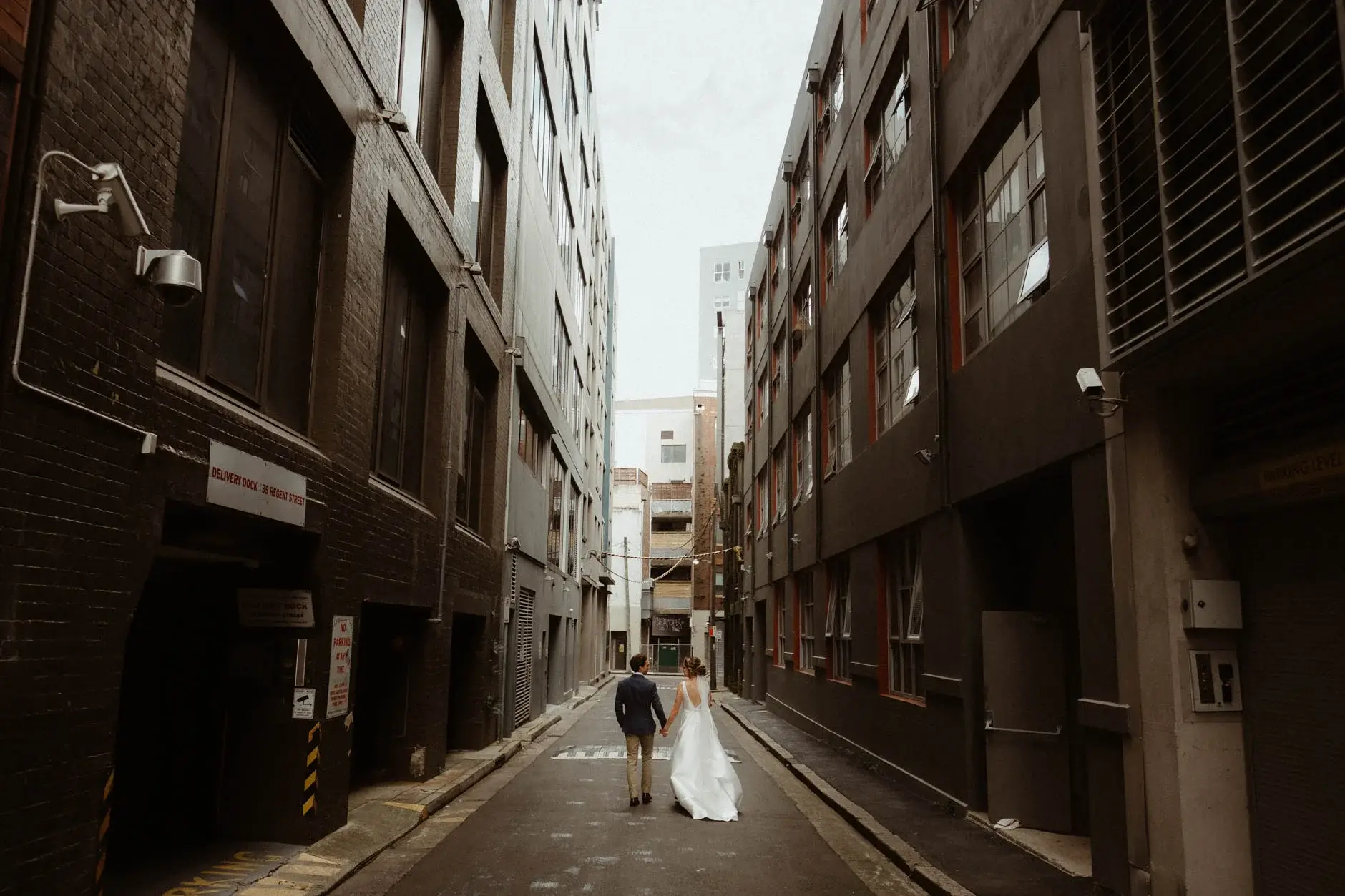 Kath and Ross far down the empty laneway, Chippendale