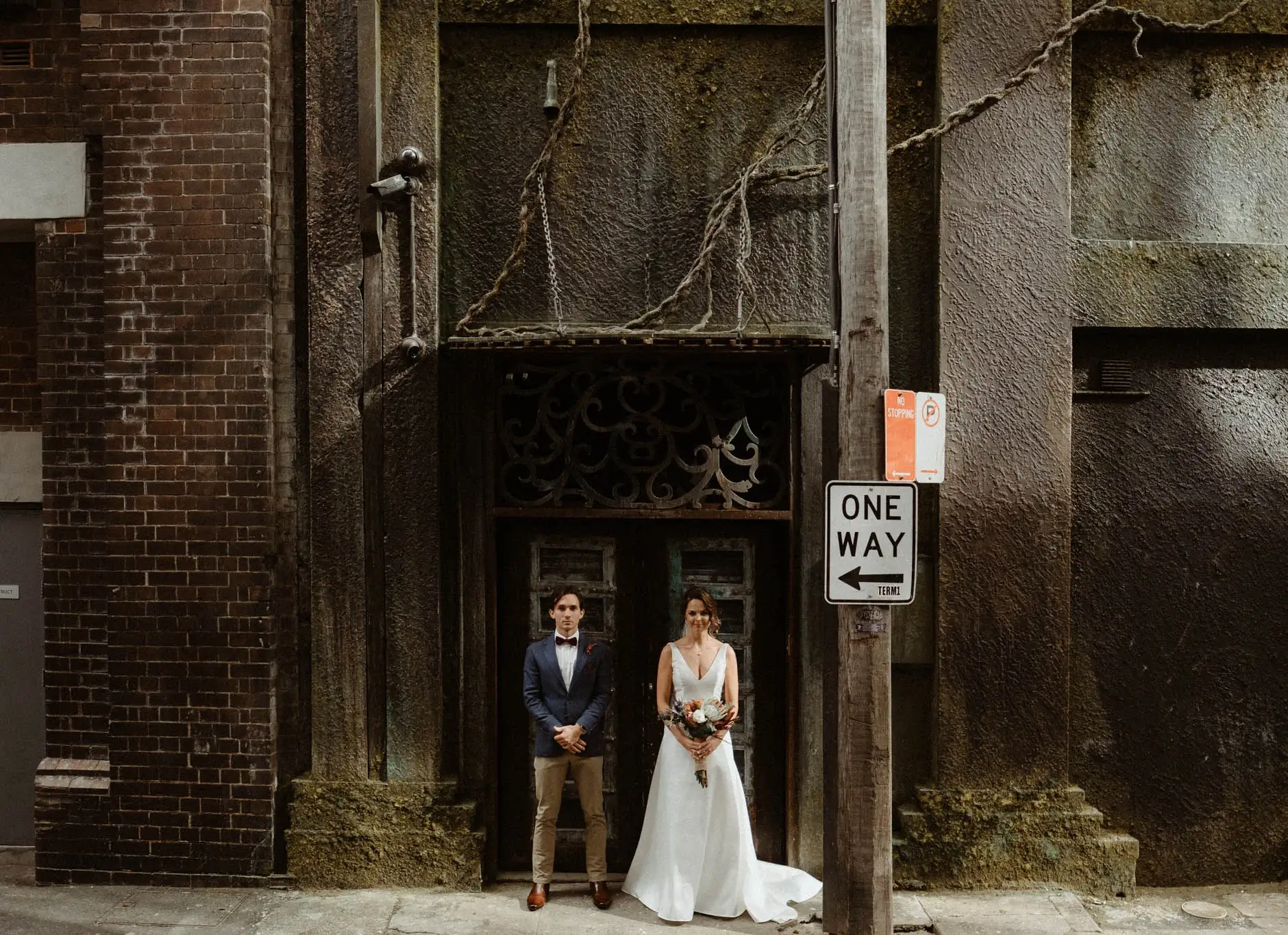 Kath and Ross in a doorway beneath the One Way sign, Chippendale