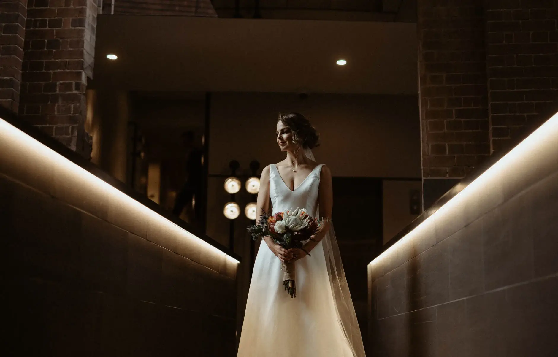Kath with her bouquet in the lit corridor, Chippendale