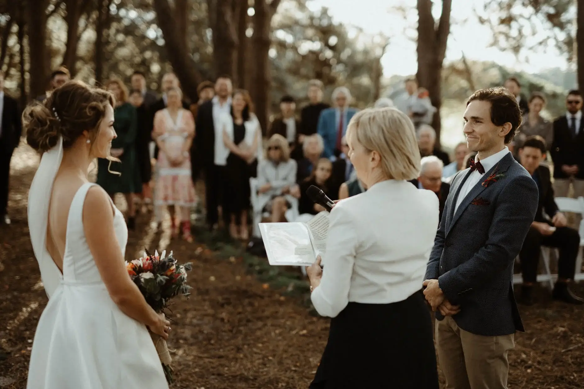 Kath and Ross facing each other with the celebrant, Centennial Park