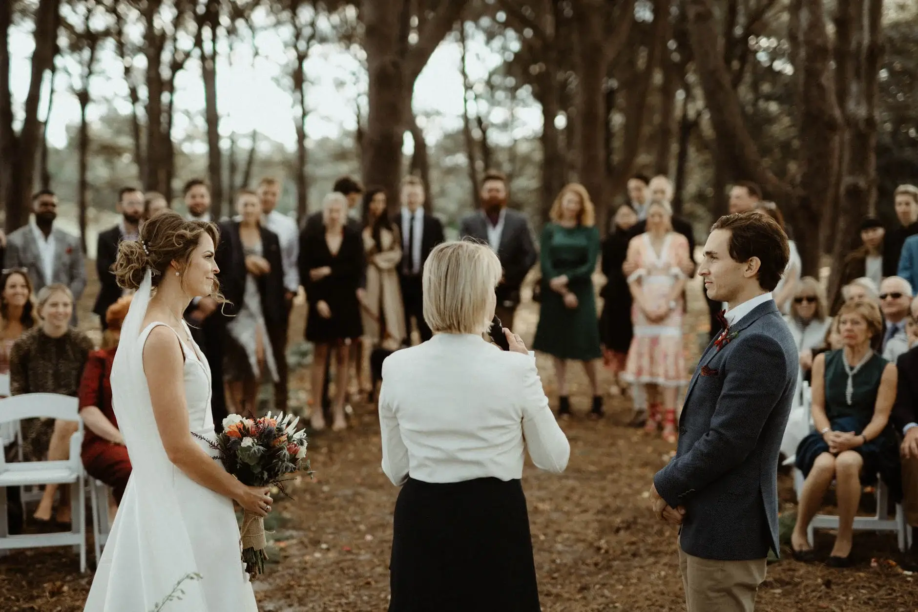 Kath holding her bouquet as Ross listens, Centennial Park