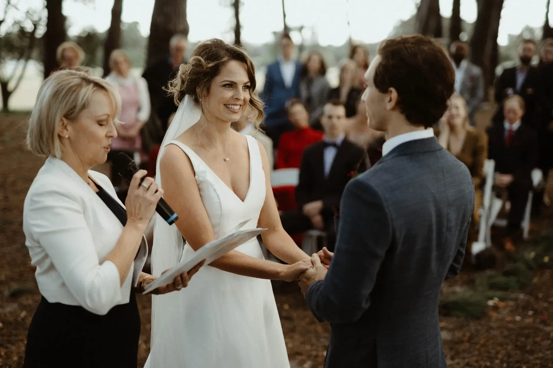 Kath and Ross holding hands during the vows, Centennial Park