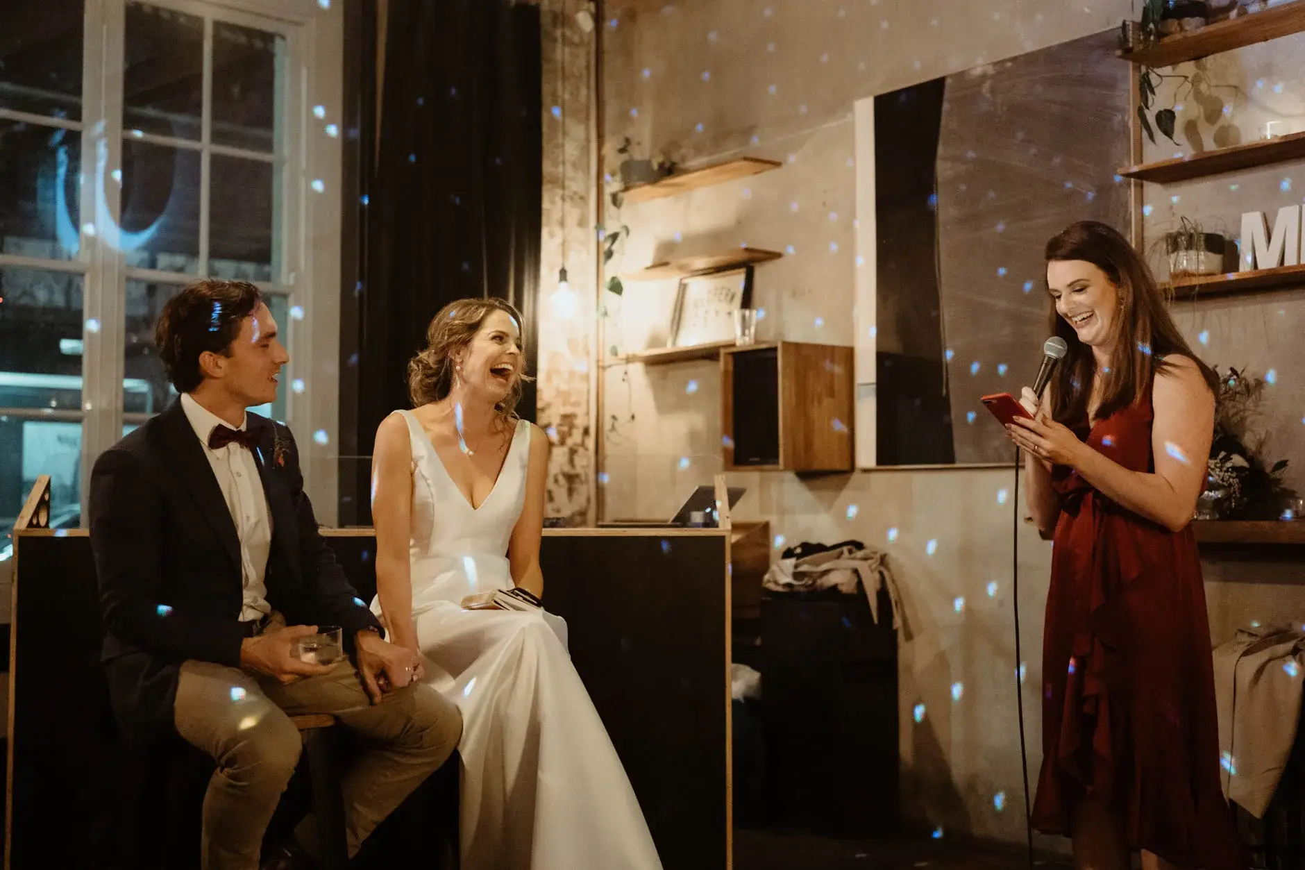 Kath and Ross sitting together at the reception, Redfern