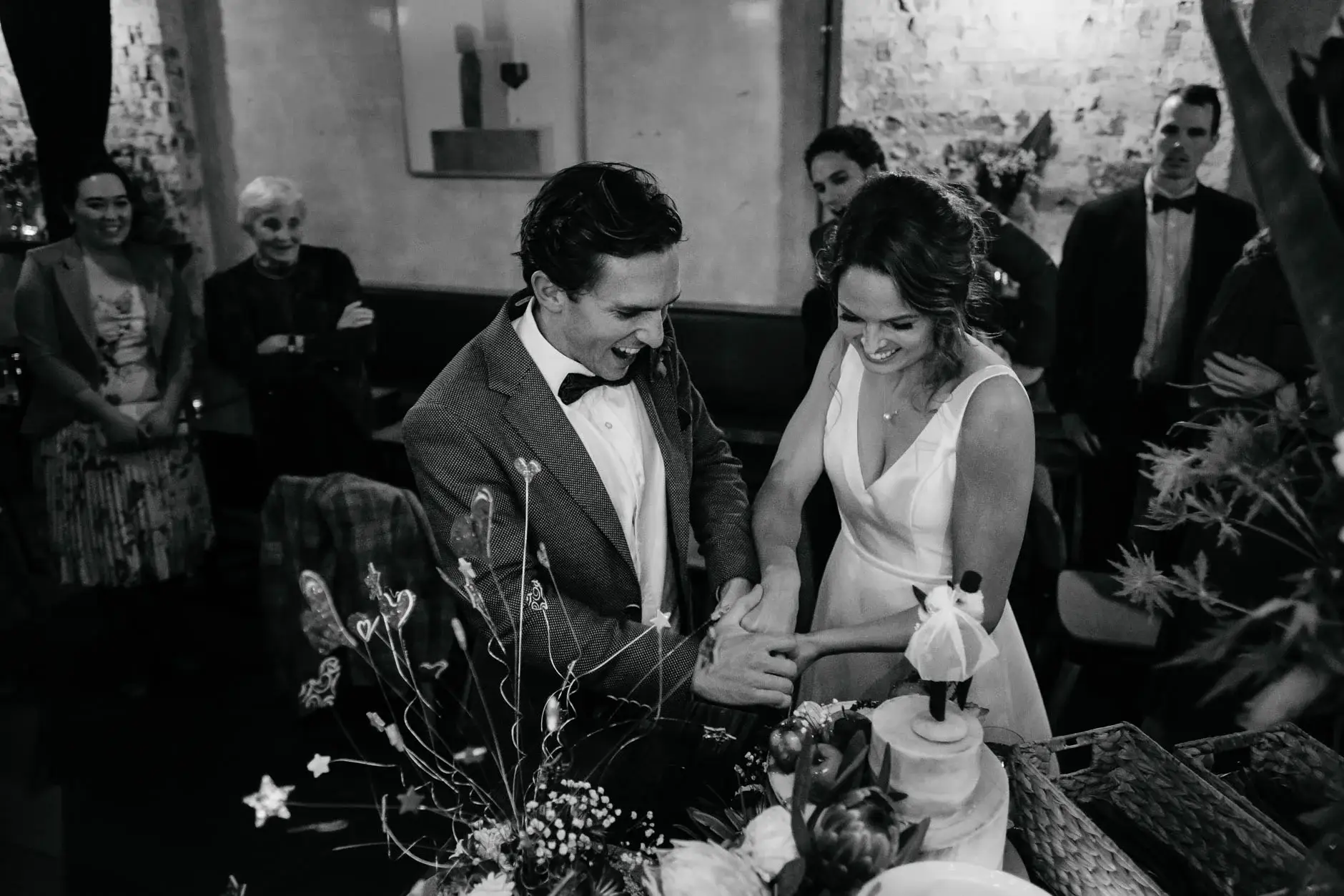 Kath and Ross cutting the cake, black and white, Redfern