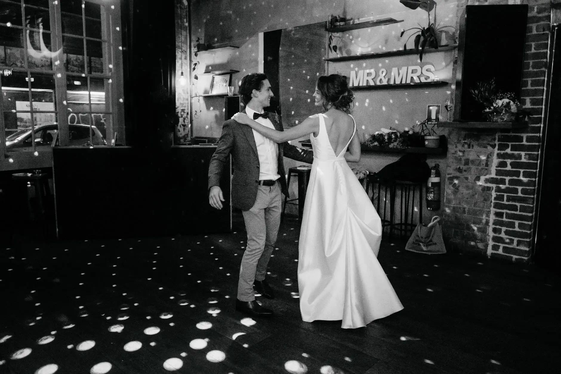 The first dance under the MR & MRS sign, black and white, Redfern