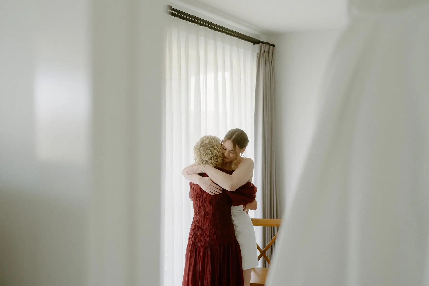 Nicole holding her mother in a long hug by the window, Kooroomba Vineyard and Lavender Farm
