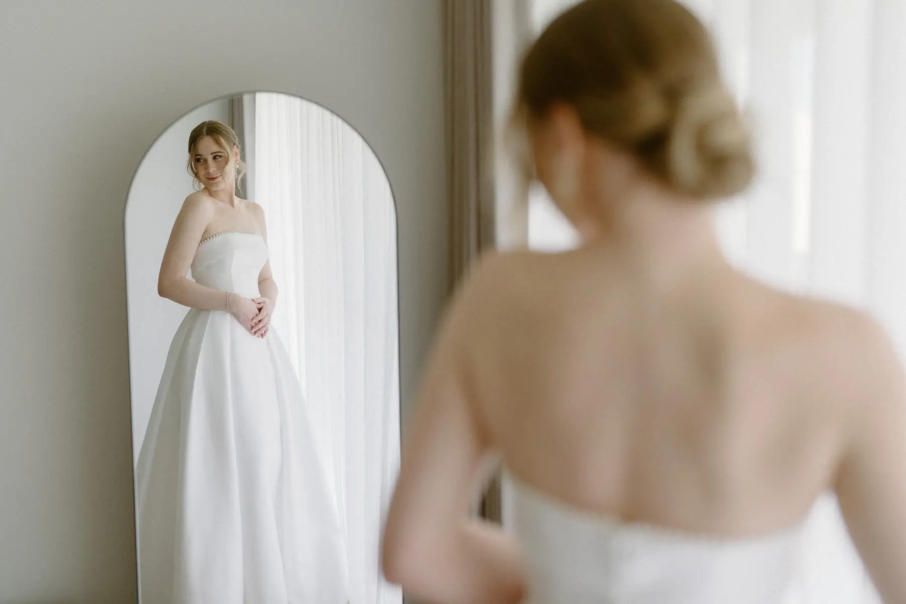 Nicole reflected in the arched mirror, and the low chignon at the back of her hair, Kooroomba Vineyard and Lavender Farm