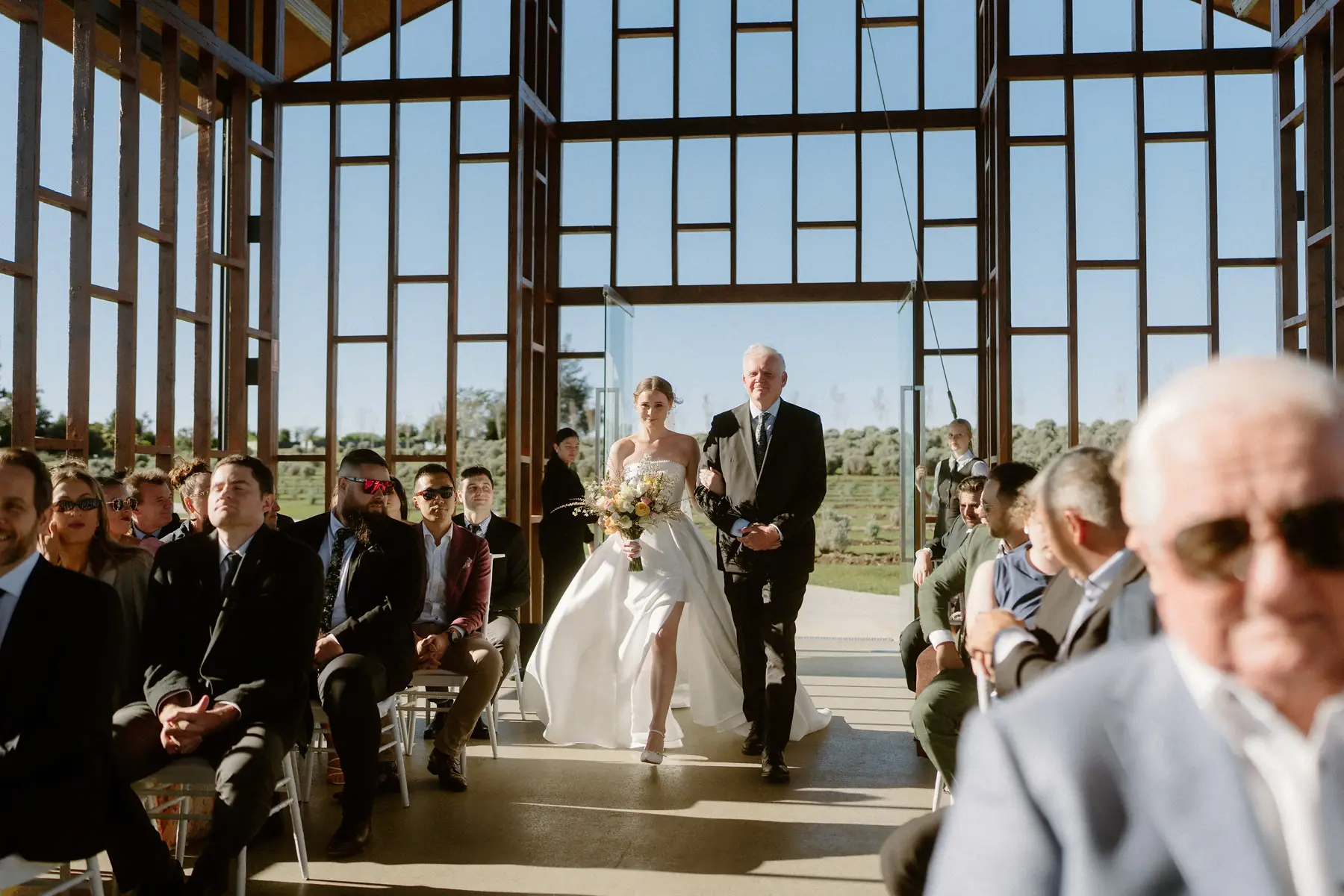 The aisle between the seated guests inside the open chapel, Kooroomba