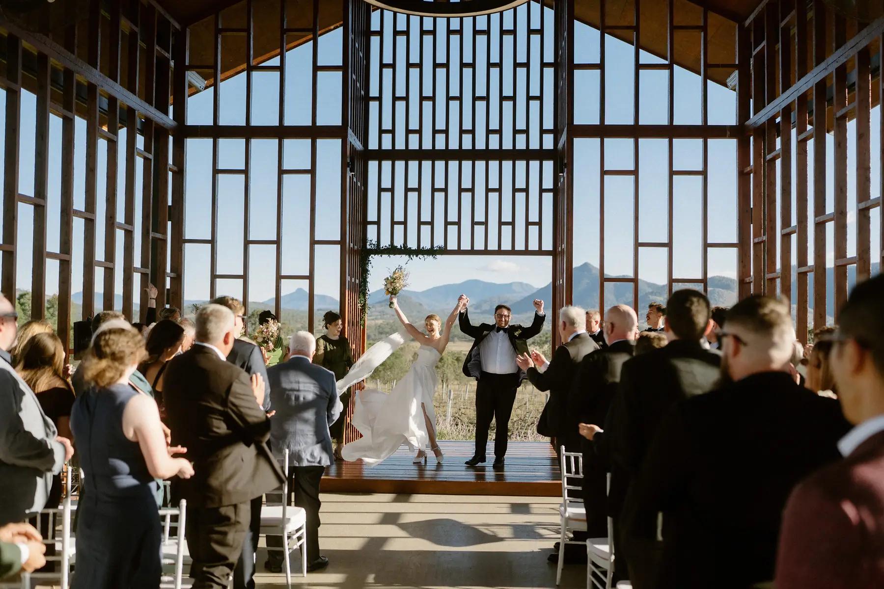 Guests on their feet either side of the aisle as the couple are announced, Kooroomba