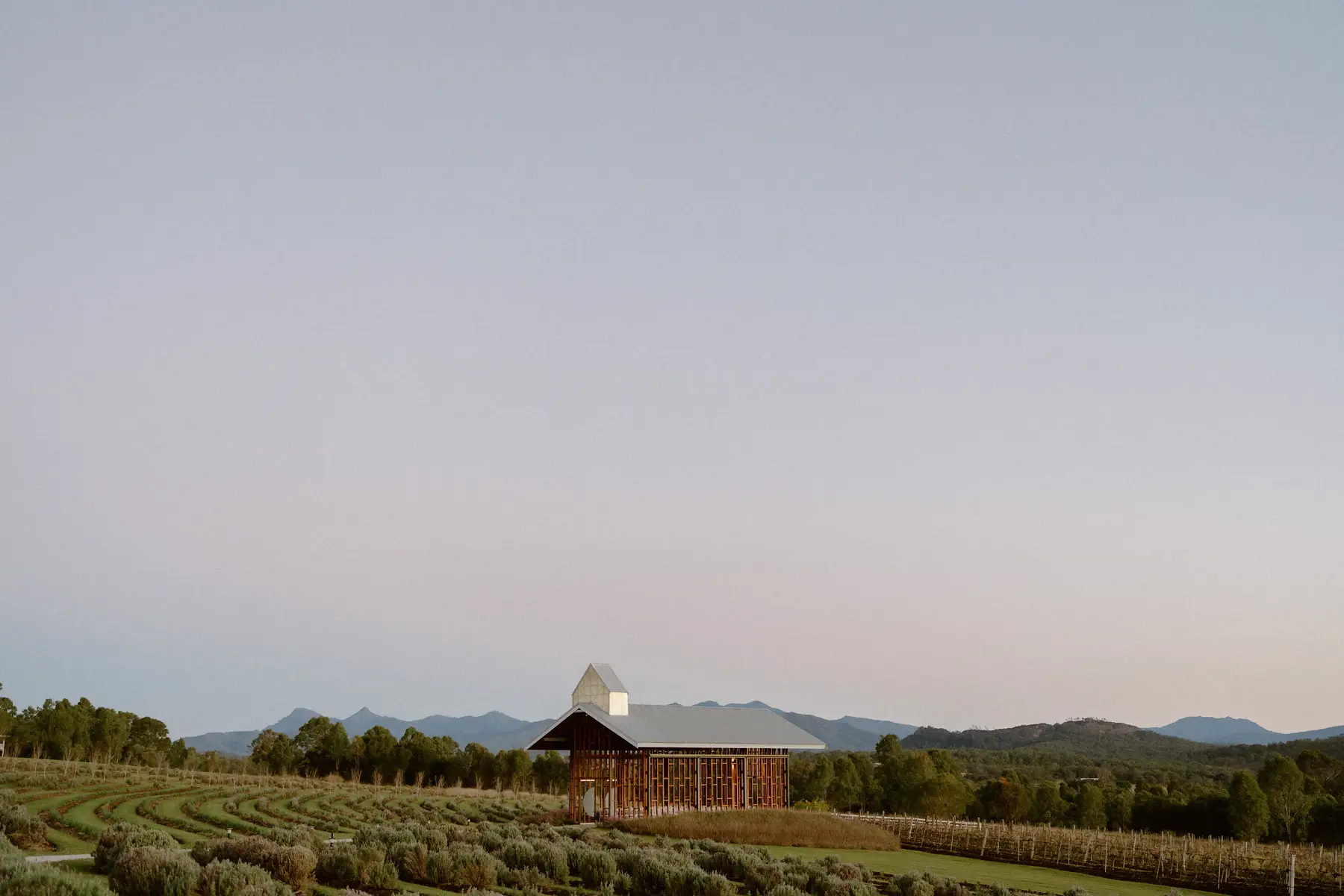 The chapel alone above the lavender rows under a pink dusk sky, Kooroomba Vineyard and Lavender Farm