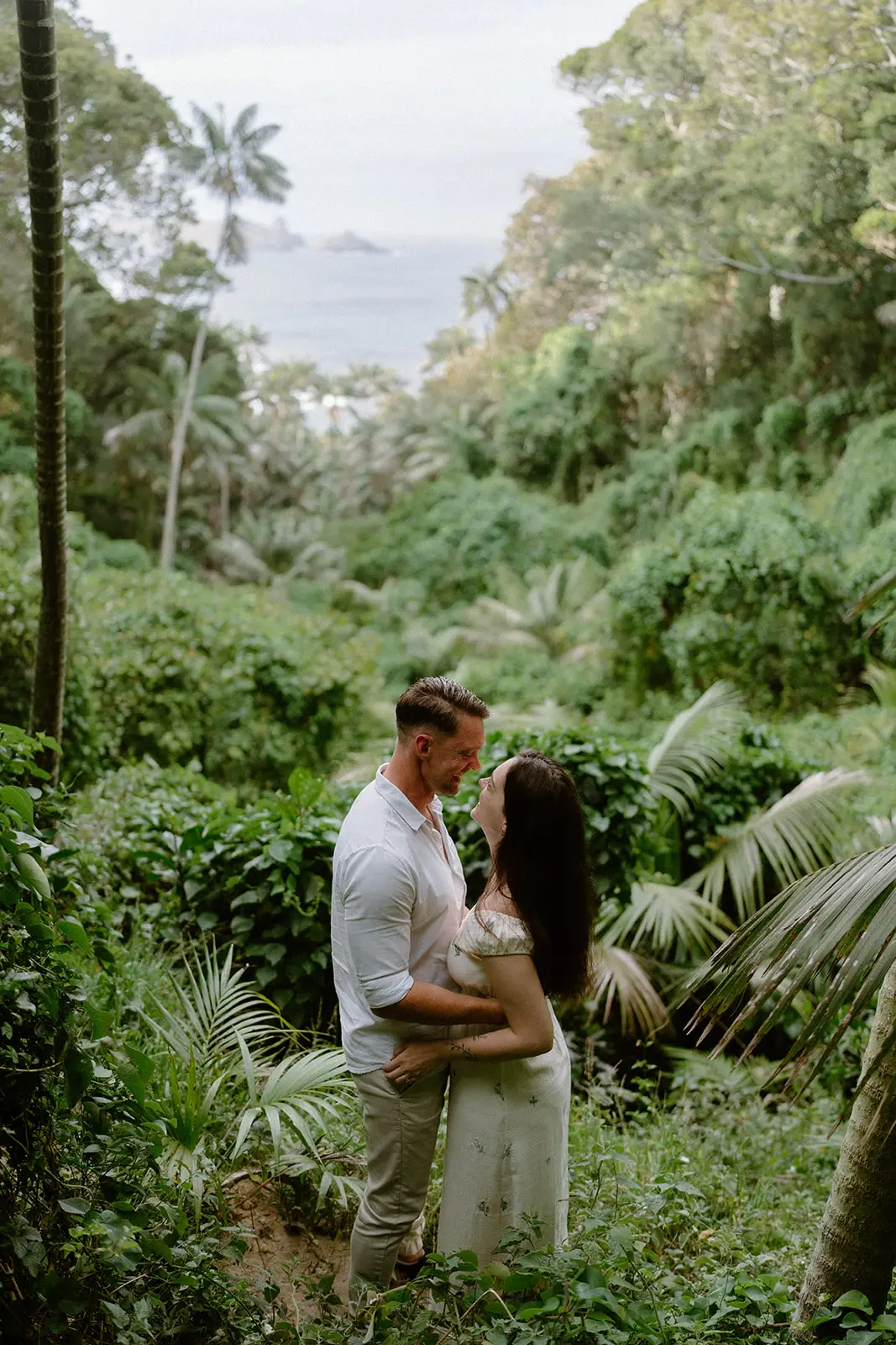 Mel and Brent embracing among the greenery, Lord Howe Island
